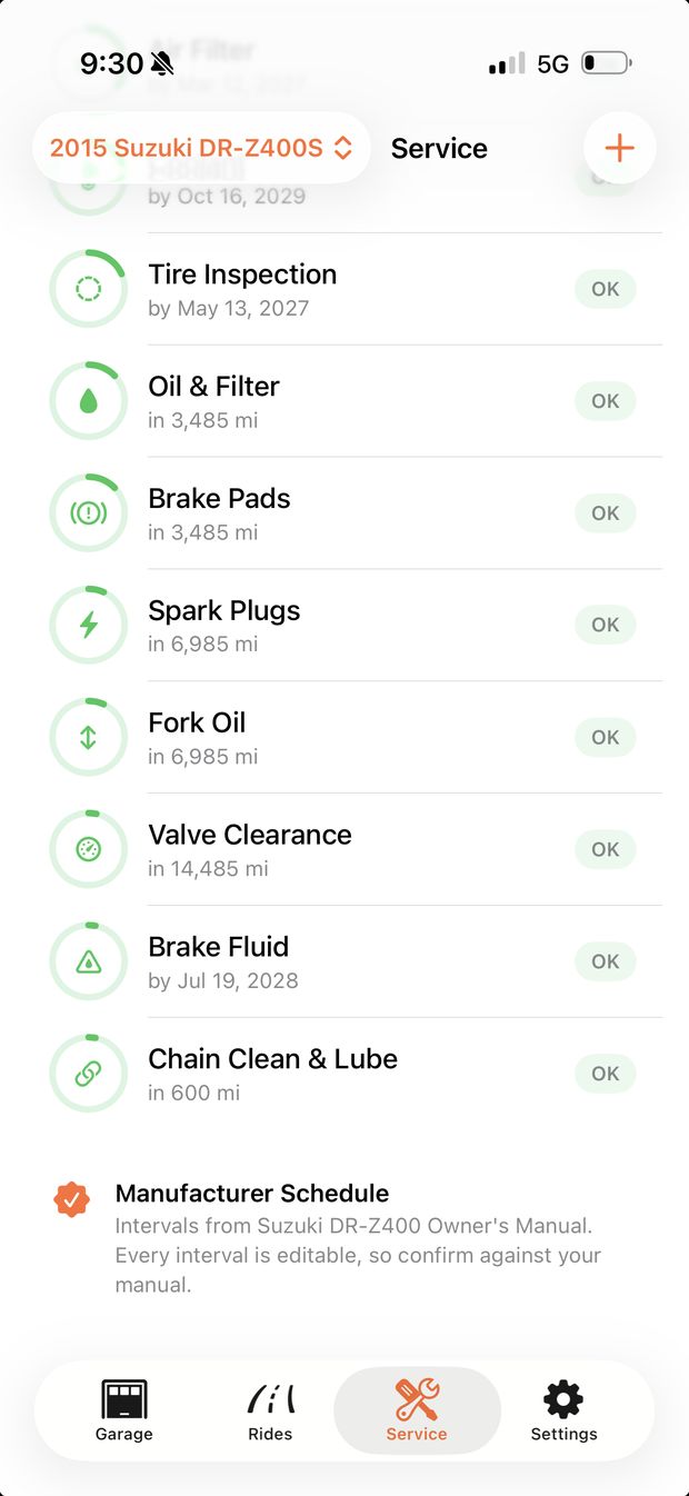 The Service tab for a 2015 Suzuki DR-Z400S: Tire Inspection, Oil and Filter, Brake Pads, Spark Plugs, Fork Oil, Valve Clearance, Brake Fluid and Chain Clean and Lube, each with its distance or date remaining, above a note naming the Suzuki DR-Z400 Owner's Manual as the source.